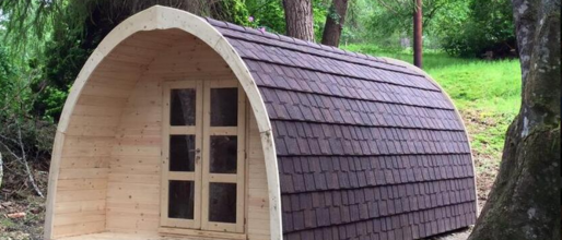 A wooden farm restaurant with trendy roofing tiles offers a luxurious look in nature's embrace.